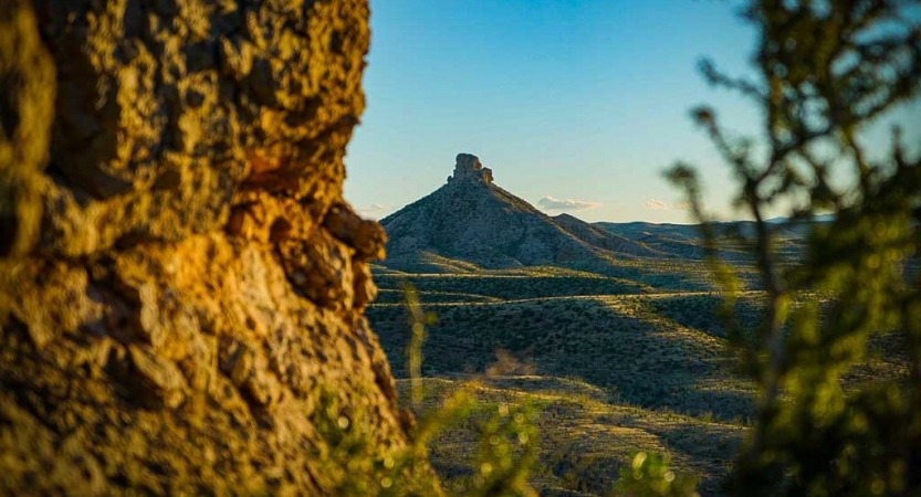 a mesa and rolling green hills in big bend, texas